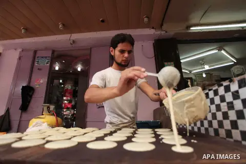 A Palestinian vendor prepares traditional pancakes known as ''Qatayef'' during the holy fasting month of Ramadan in Gaza city, on July 01, 2014. Muslims around the world refrain from eating, drinking and sexual intercour...