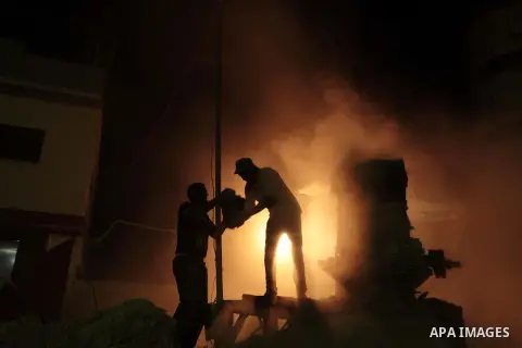 Palestinian construction workers work at night in Deir al-Balah in central Gaza Strip on 2 July 2014. Palestinian construction workers work during the night in the month of Ramadan because of the high temperatures they c...