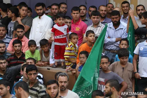 Palestinian supporters of Hamas movement take part in a rally in solidarity with the Palestinian in the West Bank and against any possible Israeli attack on Gaza, in Jabalia in the northern Gaza Strip, July 04, 2014. The...