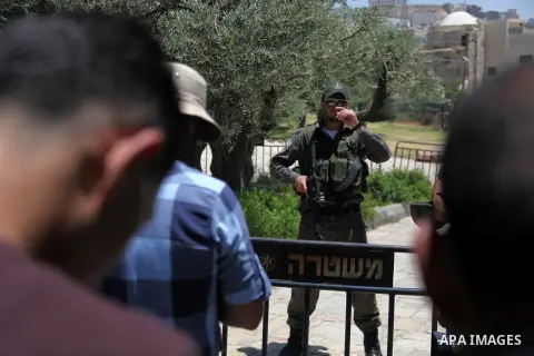 An Israeli policeman stands guard as Palestinian muslims attend the traditional Friday prayers, the first of Islam's holy month of Ramadan, at Ibrahimi mosque "Sanctuary of Abraham", in the West Bank City of Hebron July...