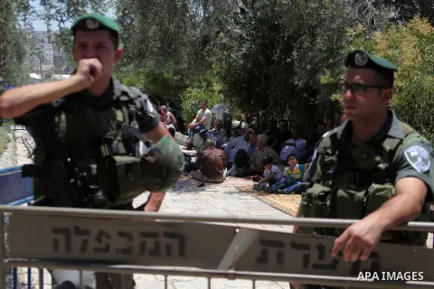 Israeli policemen stand guard as Palestinian muslims attend the traditional Friday prayers, the first of Islam's holy month of Ramadan, at Ibrahimi mosque "Sanctuary of Abraham", in the West Bank City of Hebron July 04,...