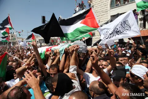 Palestinian mourners carry the body of Mohammed Abu Khder, 16, during his funeral in Shuafat, in Israeli annexed East Jerusalem on July 4, 2014. Abu Khder, a Palestinian teenager was reportedly kidnapped and killed, trig...