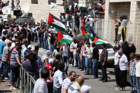 Palestinian mourners carry the body of Mohammed Abu Khder, 16, during his funeral in Shuafat, in Israeli annexed East Jerusalem on July 4, 2014. Abu Khder, a Palestinian teenager was reportedly kidnapped and killed, trig...