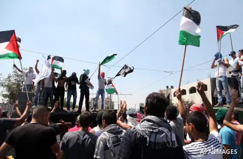 Thousands of mourners shout slogans as they gather for the funeral of Mohammed Abu Khder, 16, in Shuafat, in Israeli annexed East Jerusalem, on July 4, 2014. Abu Khder, a Palestinian teenager was reportedly kidnapped and...