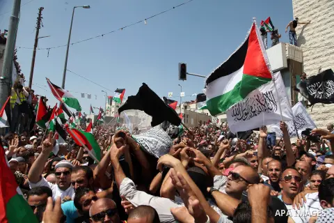 Palestinian mourners carry the body of Mohammed Abu Khder, 16, during his funeral in Shuafat, in Israeli annexed East Jerusalem on July 4, 2014. Abu Khder, a Palestinian teenager was reportedly kidnapped and killed, trig...