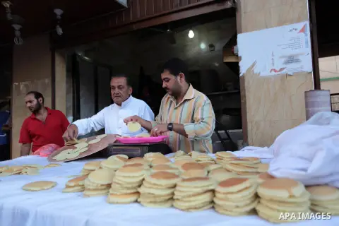 A Palestinian vendor prepares traditional pancakes known as ''Qatayef'' during the holy fasting month of Ramadan in Gaza city, on July 0, 2014. Muslims around the world refrain from eating, drinking and sexual intercours...