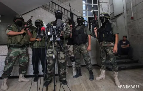 Palestinian militants of the Nasser Salah al-Din Brigades the military wing of the Popular Resistance Committees take part in a press conferenceon on cross-border escalation between Palestinians and Israel, in Gaza City...