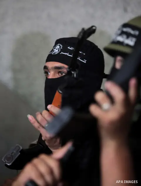 Palestinian militants of the Nasser Salah al-Din Brigades the military wing of the Popular Resistance Committees take part in a press conferenceon on cross-border escalation between Palestinians and Israel, in Gaza City...