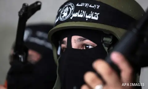 Palestinian militants of the Nasser Salah al-Din Brigades the military wing of the Popular Resistance Committees take part in a press conferenceon on cross-border escalation between Palestinians and Israel, in Gaza City...