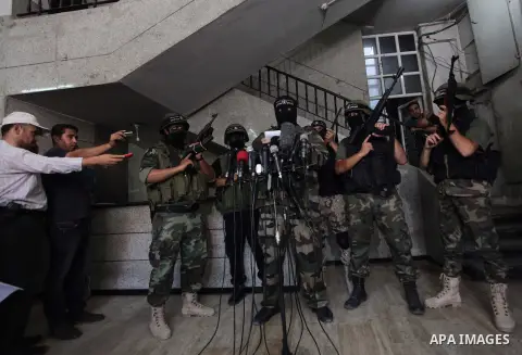 Palestinian militants of the Nasser Salah al-Din Brigades the military wing of the Popular Resistance Committees take part in a press conferenceon on cross-border escalation between Palestinians and Israel, in Gaza City...