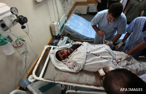 Medics prepare the body of a Palestinian militant at a hospital in Deir al-Balah in the central Gaza Strip July 6, 2014. Tensions were high along the Gaza border where Israel killed two Palestinian militants and wounded...