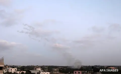Smoke trails are seen as a rocket is launched from the east Gaza City towards Israel on July 07, 2014. Israeli air strikes on Gaza, that killed at least seven Palestinian militants overnight, came after a day in which ar...