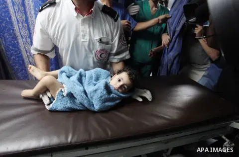 A Palestinian girl, who medics said was wounded in an Israeli air strike, arrives at al-Shifa hospital in Gaza city July 8, 2014. Israel launched an aerial offensive in the Gaza Strip on Tuesday, bombing more than 30 tar...