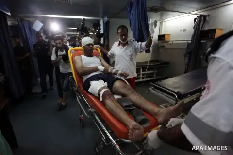 Palestinian medics wheel an injured man following an Israeli air strike at al-Shifa hospital in Gaza city July 8, 2014. Israel launched an aerial offensive in the Gaza Strip on Tuesday, bombing more than 30 targets inclu...