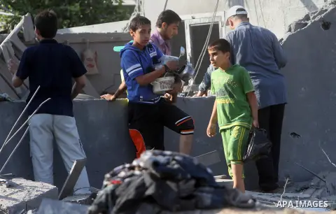 Palestinians inspect a house which police said was destroyed in an Israeli air strike in Khan Younis in the southern Gaza Strip July 8, 2014. Israel launched an offensive against Islamist Hamas in the Gaza Strip on Tuesd...