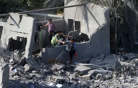 Palestinians inspect a house which police said was destroyed in an Israeli air strike in Khan Younis in the southern Gaza Strip July 8, 2014. Israel launched an offensive against Islamist Hamas in the Gaza Strip on Tuesd...