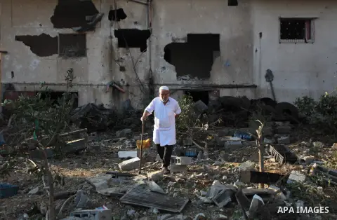 Palestinians inspect a house which police said was damaged in an Israeli air strike in Gaza City July 10, 2014. Israel pressed on with a punishing aerial offensive in Gaza for a third day on Thursday, killing eight membe...
