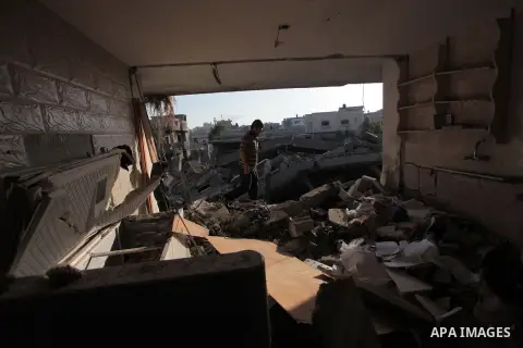 Palestinians inspect a house which police said was damaged in an Israeli air strike in Gaza City July 10, 2014. Israel pressed on with a punishing aerial offensive in Gaza for a third day on Thursday, killing eight membe...