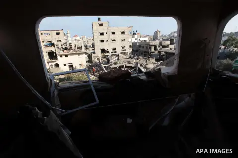 Palestinians inspect a house which police said was damaged in an Israeli air strike in Gaza City July 10, 2014. Israel pressed on with a punishing aerial offensive in Gaza for a third day on Thursday, killing eight membe...