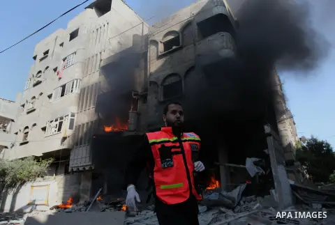 Members of civil defence and another man try to extinguish a fire caused after what police said was an Israeli air strike on a house, in Gaza City July 10, 2014. Israel pressed on with a punishing aerial offensive in Gaz...