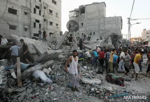 Smoke rises from buildings following what witnesses said was an Israeli air strike, as Palestinians search for victims under the rubble of a house which police said was destroyed in another Israeli air strike in Rafah in...