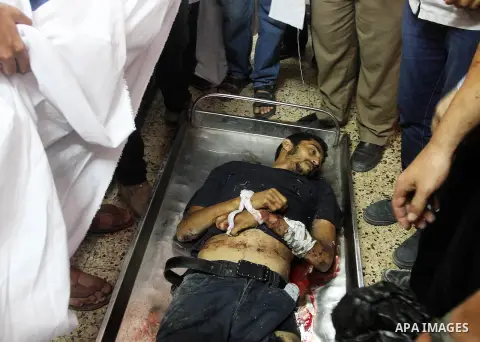 Palestinian relatives mourn over the body of Mahmud al-Sewati during his funeral in Gaza City on 12 July 2014. Israel vowed no let-up in its aerial bombardment of Gaza, which has claimed more than 100 Palestinian lives,...