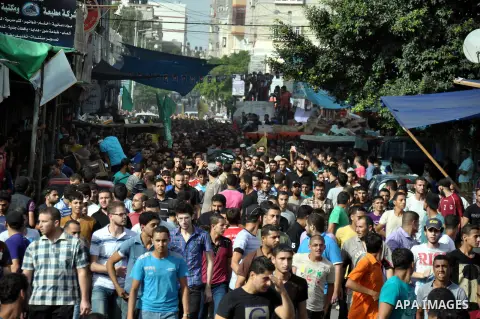 Relatives and friends of a Palestinian, who was killed in an Israeli air raid, carry his body during his funeral in Gaza City, on July 12, 2014. Eight Palestinians were killed in a series of Israeli raids in the Gaza Str...