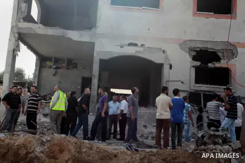Palestinians search the rubble of Tayseer Al-Batsh's family house, which police said was destroyed in an Israeli air strike in Gaza City July 13, 2014. The Israeli air strike on the home of Al-Batsh, Gaza's police chief,...