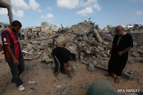 Palestinians inspect the rubble of Tayseer Al-Batsh's family house, which police said was destroyed in an Israeli air strike in Gaza City July 13, 2014. The Israeli air strike on the home of Al-Batsh, Gaza's police chief...