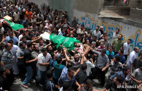 Palestinians carry the body of one of the Palestinian members of Tayseer Al-Batsh's family, who hospital officials said were killed in an Israeli air strike, during their funeral in Gaza City July 13, 2014. The Israeli a...