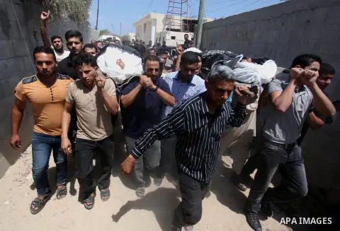 Palestinians carry the bodies of two Islamic Jihad militants brothers Mohammed and Ahmad Abu Youssif during their funeral in Khan younis refugee camp in the southern Gaza strip on, 15 July 2015. The two brothers were kil...