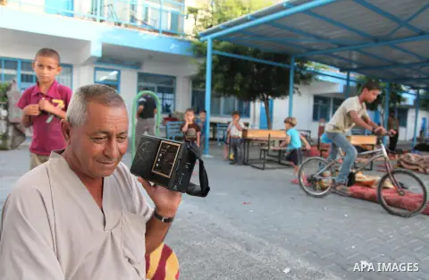 Palestinians take shelter at a UN school in the northern Gaza Strip town of Beit Lahiya early on July 16, 2014, after evacuating their houses near the border with Israel. The Israeli army has warned some 100,000 Palestin...