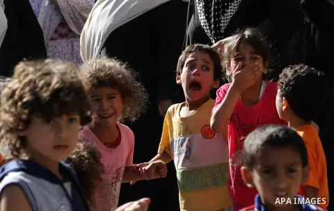 Relatives of Palestinian children from the Baker family, whom medics said was killed by a shell fired by an Israeli naval gunboat, mourn during their funeral in Gaza City July 16, 2014. Four Palestinian children were kil...