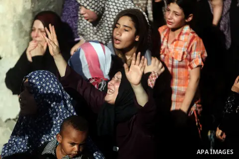 Relatives of four Palestinian children from the Baker family, whom medics said were killed by a shell fired by an Israeli naval gunboat, mourn during their funeral in Gaza City July 16, 2014. Four Palestinian children we...