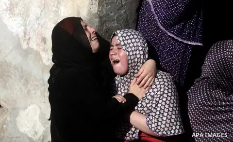 Relatives of four Palestinian children from the Baker family, whom medics said were killed by a shell fired by an Israeli naval gunboat, mourn during their funeral in Gaza City July 16, 2014. Four Palestinian children we...