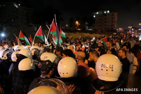 Palestinian policemen prevent protesters during a demonstration against the Israeli military action in Gaza strip, in at the Beit Eil near the West Bank city of Ramallah, on July 17, 2014. Israeli shelling killed four Pa...