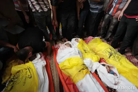 Palestinian relatives of the Abu Jarad family mourn during the funeral of eight family members in Gaza, 19 July 2014. Since the start of Israel's offensive in Gaza on 08 July, which it says is aimed at ending rocket fire...