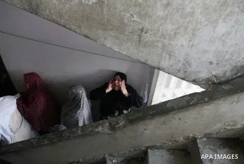 Palestinian relatives mourns over the body of thier son Emad Elwan, 7, who was killed along with his brother in an Israeli tank shell the day before, on July 19, 2014 during their funeral in Gaza City. Palestinian presid...