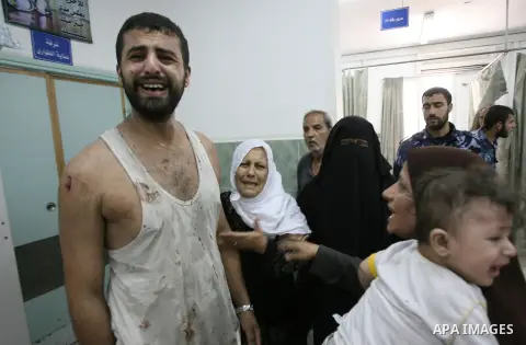 Palestinians mourn the death of a relative after hit by an Israeli air strike at a hospital in Rafah in the southern Gaza Strip July 20, 2014. The death toll in Gaza passed 400 as Israel pressed its biggest offensive in...