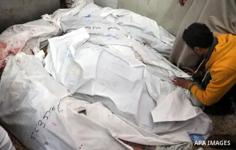 Palestinians inspect the bodies of their relatives at the morgue of the al-Shifa hospital in Gaza City, on July 20, 2014 July 20, 2014. The death toll in Gaza passed 400 as Israel pressed its biggest offensive in the enc...