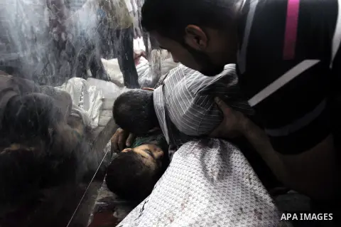Palestinians inspect the bodies of their relatives at the morgue of the al-Shifa hospital in Gaza City, on July 20, 2014 July 20, 2014. The death toll in Gaza passed 400 as Israel pressed its biggest offensive in the enc...