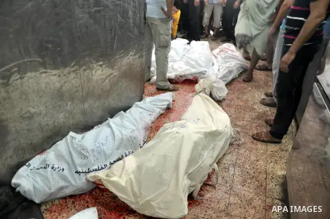 Palestinians inspect the bodies of their relatives at the morgue of the al-Shifa hospital in Gaza City, on July 20, 2014 July 20, 2014. The death toll in Gaza passed 400 as Israel pressed its biggest offensive in the enc...