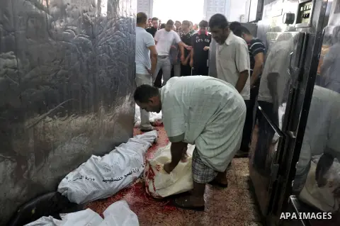 Palestinians inspect the bodies of their relatives at the morgue of the al-Shifa hospital in Gaza City, on July 20, 2014 July 20, 2014. The death toll in Gaza passed 400 as Israel pressed its biggest offensive in the enc...