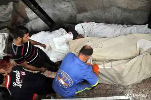 Palestinians inspect the bodies of their relatives at the morgue of the al-Shifa hospital in Gaza City, on July 20, 2014 July 20, 2014. The death toll in Gaza passed 400 as Israel pressed its biggest offensive in the enc...