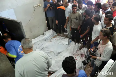 Palestinians inspect the bodies of their relatives at the morgue of the al-Shifa hospital in Gaza City, on July 20, 2014 July 20, 2014. The death toll in Gaza passed 400 as Israel pressed its biggest offensive in the enc...