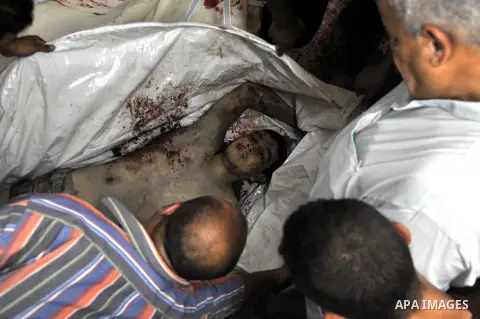 Palestinians inspect the bodies of their relatives at the morgue of the al-Shifa hospital in Gaza City, on July 20, 2014 July 20, 2014. The death toll in Gaza passed 400 as Israel pressed its biggest offensive in the enc...