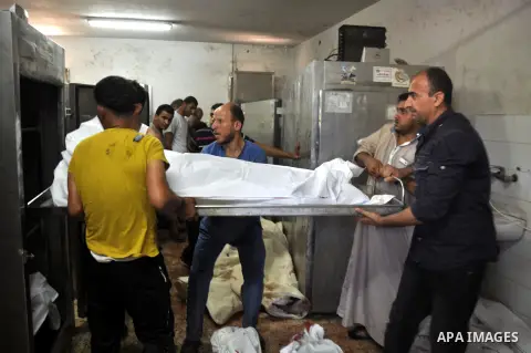 Palestinians inspect the bodies of their relatives at the morgue of the al-Shifa hospital in Gaza City, on July 20, 2014 July 20, 2014. The death toll in Gaza passed 400 as Israel pressed its biggest offensive in the enc...