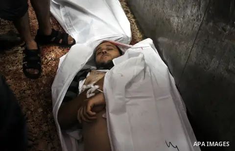 Palestinians inspect the bodies of their relatives at the morgue of the al-Shifa hospital in Gaza City, on July 20, 2014 July 20, 2014. The death toll in Gaza passed 400 as Israel pressed its biggest offensive in the enc...