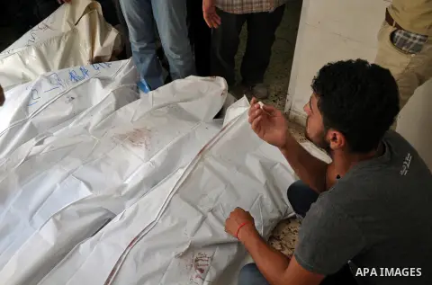 Palestinians inspect the bodies of their relatives at the morgue of the al-Shifa hospital in Gaza City, on July 20, 2014 July 20, 2014. The death toll in Gaza passed 400 as Israel pressed its biggest offensive in the enc...