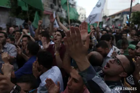 Palestinian protesters shout slogans and hold signs during a demonstration against Israel's military action and violence in the Gaza strip, in West Bank City of Ramallah July 20, 2014. Israeli strikes on Gaza on Sunday,...